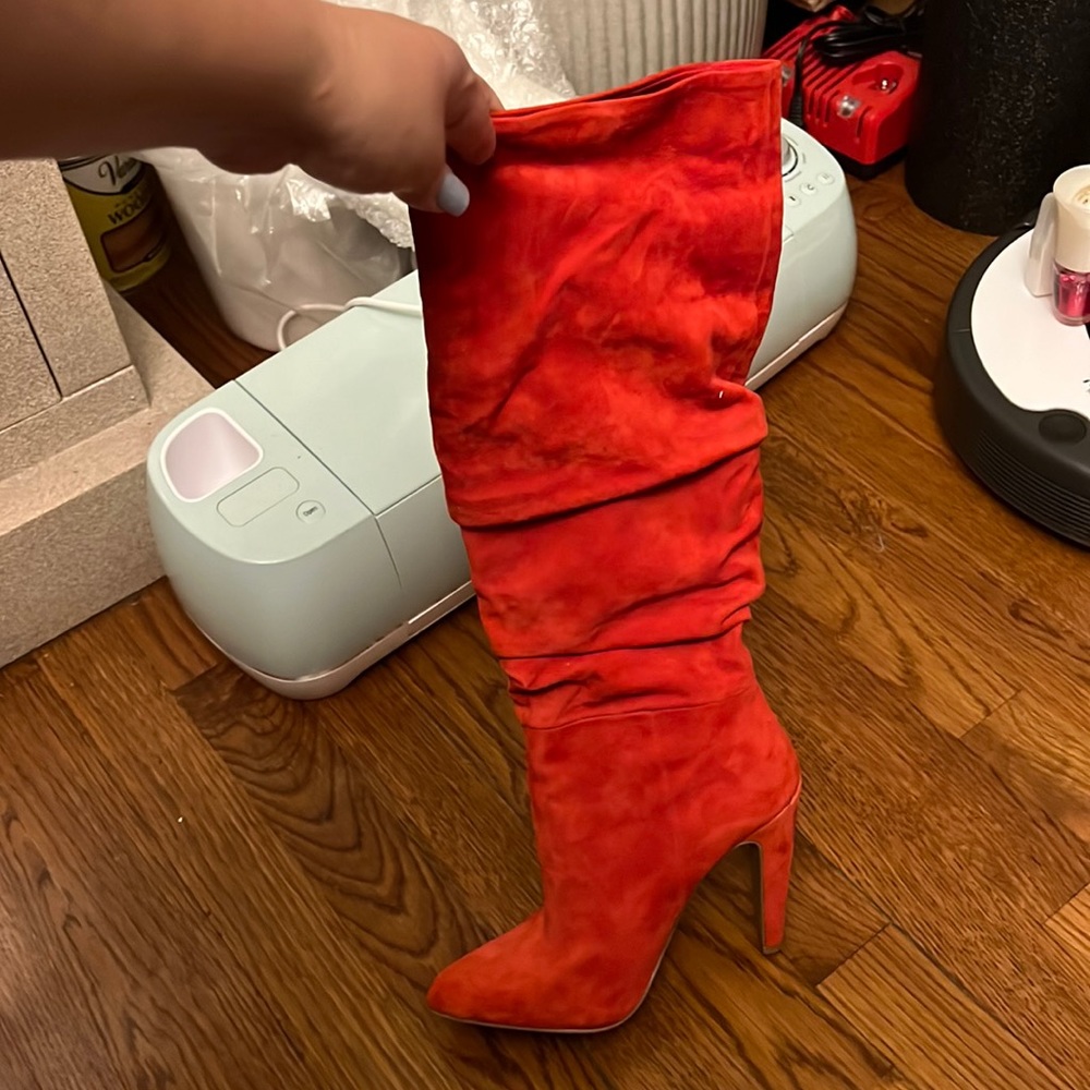 Knee high red high heeled boots